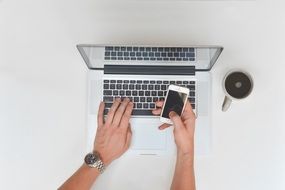 desk hands printing laptop cup coffee