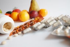 Vitamins and fruits on the table