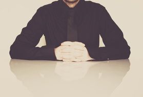 businessman in black at a table in the office
