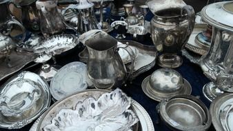 vintage silver dishware on market stand