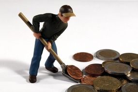 figure of a man rowing money with a shovel