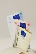 a close up of Euro banknotes in the piggy bank