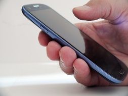 mobile phone with a camera in hand