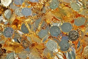 coins on the background of gold jewels