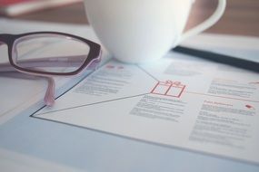 Close up photo of Eyeglasses and coffee