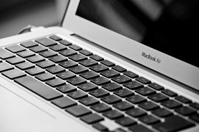 Black and white Macbook air with black screen