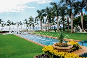 luxury tropical park with fountain at seashore