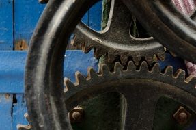 industrial gears on a background of blue fence