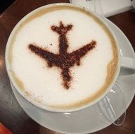 a cup of coffee with an airplane pattern