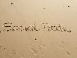 word social media on the sand