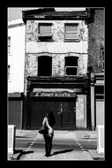 Black and white photo of lonely girl on a street