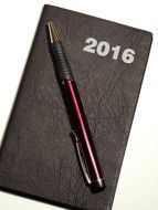 pen and a weekly calendar for business planning