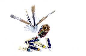 brushes, pencils and paints on the table