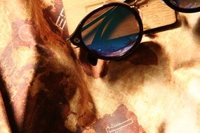 Sunglasses on a background map of the world
