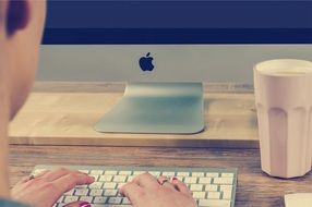 man typing on mac keyboard