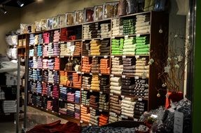 sweaters folded on shelves in a store