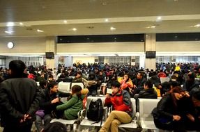 many people in the waiting room of the station