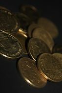 gold coins on a black surface
