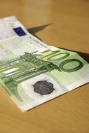 100 euro banknote on brown surface