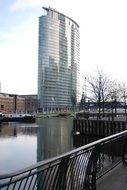 view of the wharf in the background of a skyscraper in the business district of canary wharf