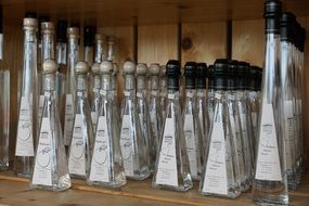 brandy bottles at wooden shelf