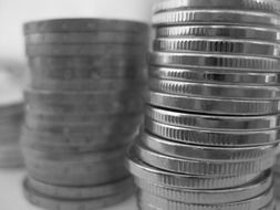 Black and white photo of stacks of coins