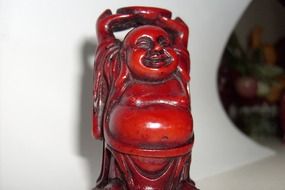 red figure of a money buddha