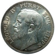 Silver coin with the face on it