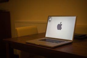 a macbook on a wooden desk