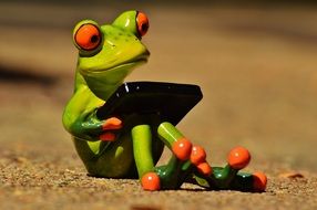 ceramic frog with computer