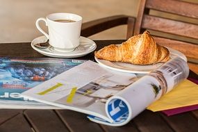 coffee break with croissant and magazine