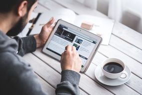 man reading blog on touchscreen