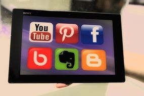 icons of social media on the tablet screen