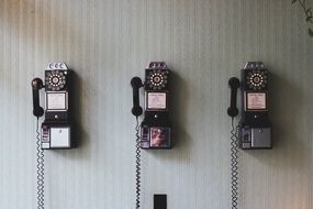 Three retro telephones on the wall