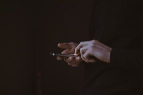 person holding a mobile phone in their hands
