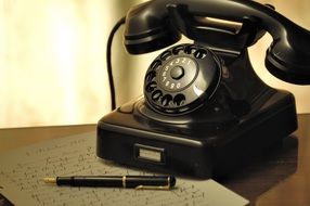 Paper with pen near the phone