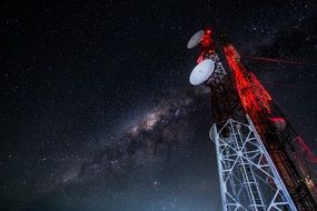 communications tower against a starry sky