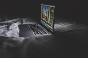 macbook on bed sheets