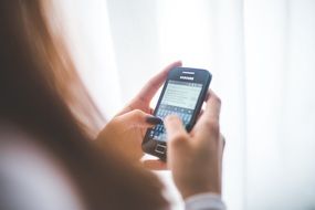 girl typing a message in smartphone