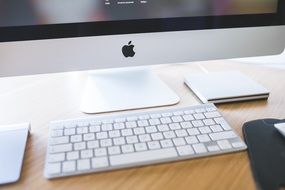 white keyboard near the monitor