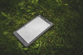 wet tablet on the grass