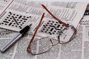 puzzling crossword in a newspaper