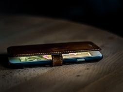 mobile phone in a case on a table