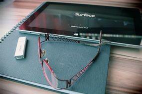 reading glasses, usb stick and tablet