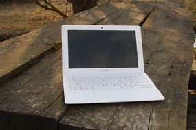 White laptop on a wooden surface