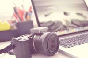 black camera and a silver laptop