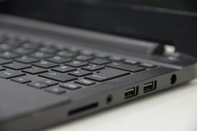 slots and keyboard on laptop closeup