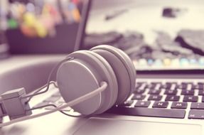 White headphones on the black and white laptop keyboard