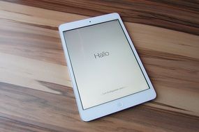 white ipad mini on a wooden table