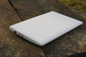 white laptop on a wooden table